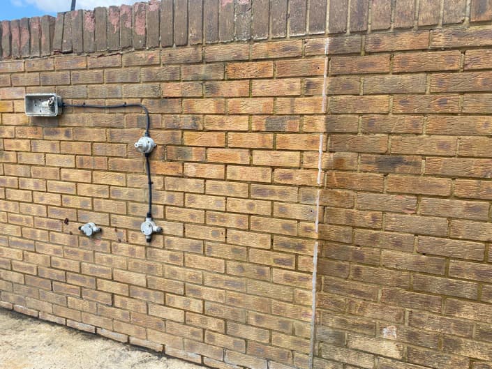 Graffiti being removed from a wall